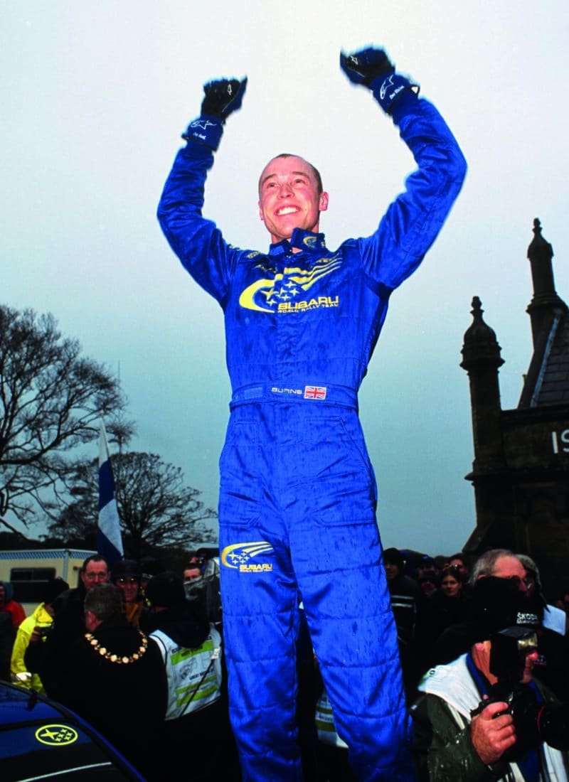 Richard Burns stands on his car after winning the World Rally Championship at the 2001 British Rally