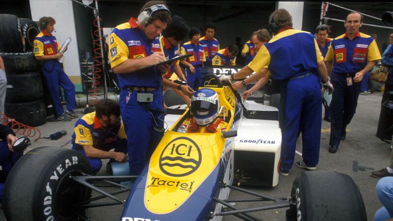 Keke Rosberg in his Williams-Honda in the pits before the 1985 Portugese Grand Prix in Estoril. Also in the picture: Team principal Frank Williams and technical director Patrick Head. Photo: Grand Prix Photo