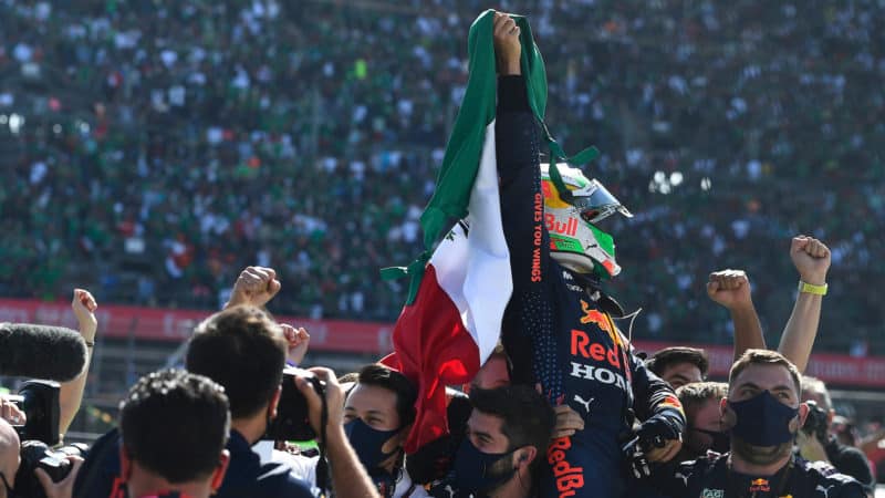 Sergio Perez celebrates in front of fans at the 2021 Mexican Grand Prix