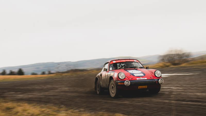 Tuthill Porsche sliding through mud on Roger Albert Clark Rally