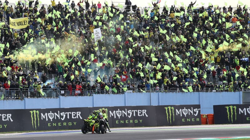 Valentino Rossi in front of a stand full of VR46 fans at Misano