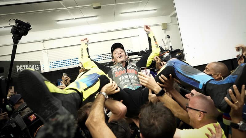 Valentino Rossi is carried by his team after his final MotoGP race