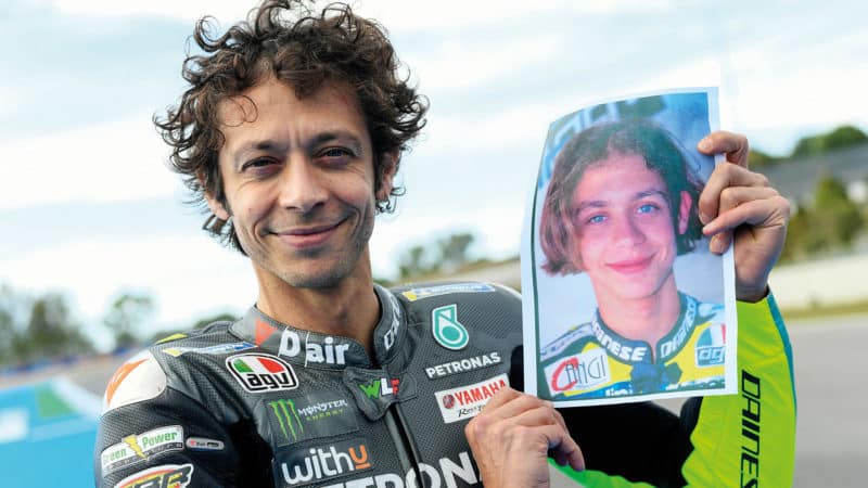 Valentino Rossi with photo of himself as a young rider