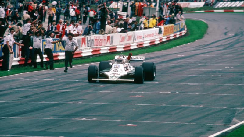 Alan Jones celebrates at the end of 1980 British Grand Prix