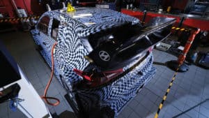 Camouflaged Hyundai i20N Rally1 car charging