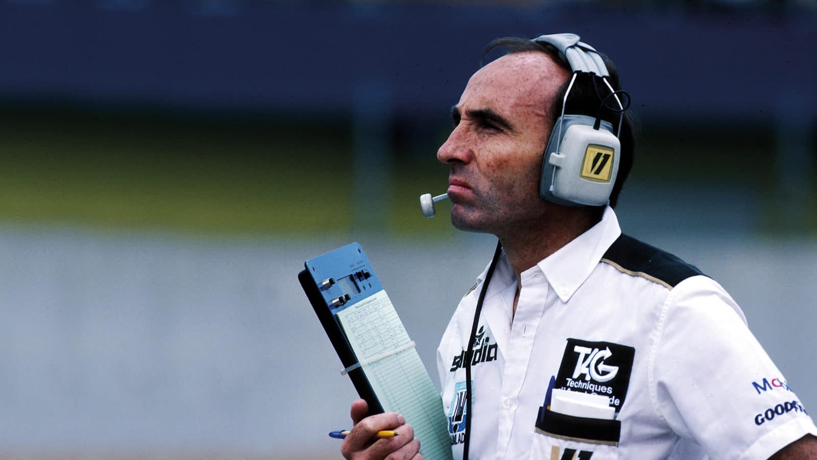 Frank Williams with clipboard and headphones