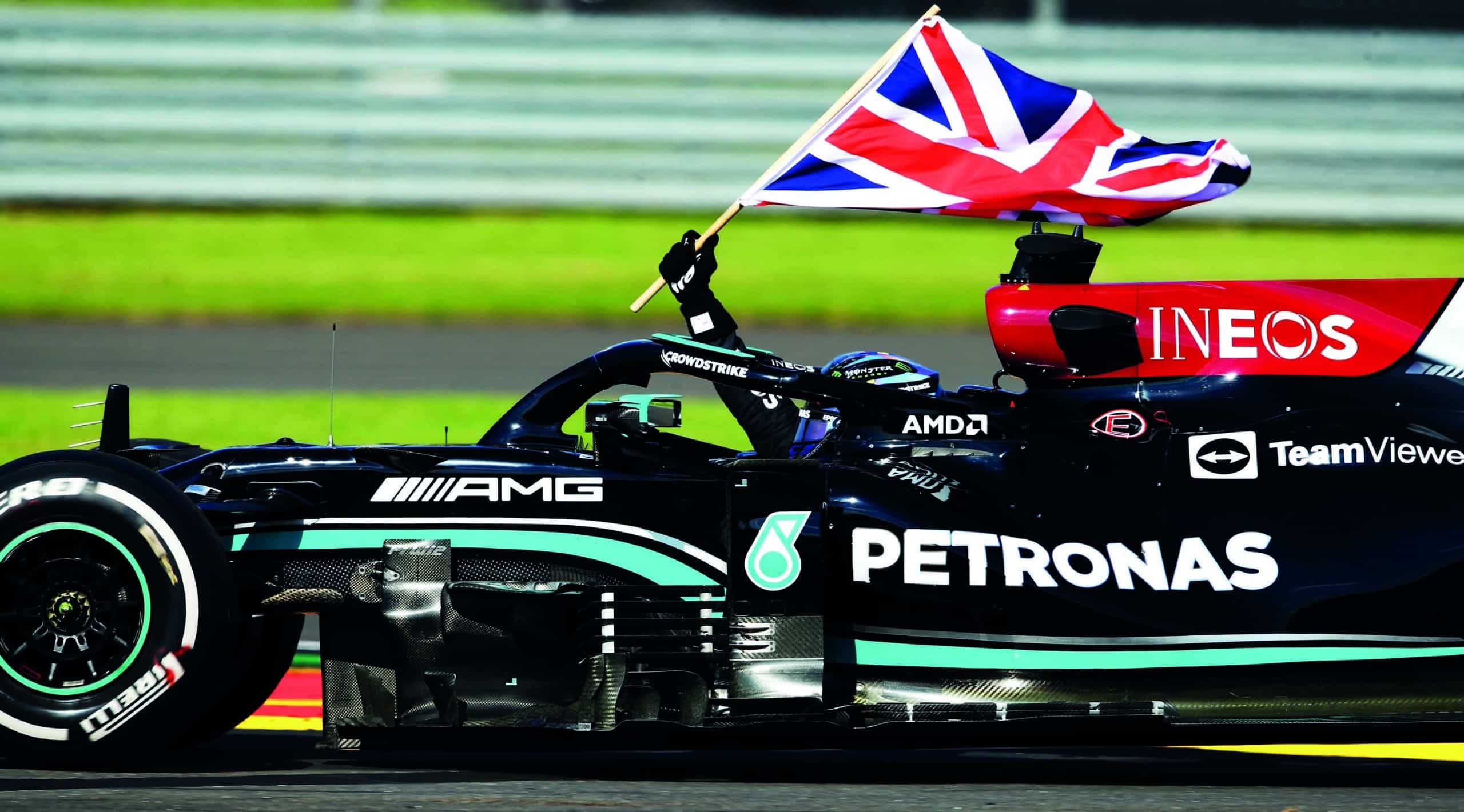 Lewis-Hamilton-drives-with-the-Union-Jack-after-winning-the-2021-British-Grand-Prix