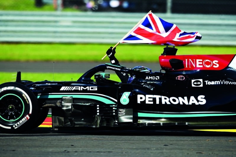 Lewis-Hamilton-drives-with-the-Union-Jack-after-winning-the-2021-British-Grand-Prix