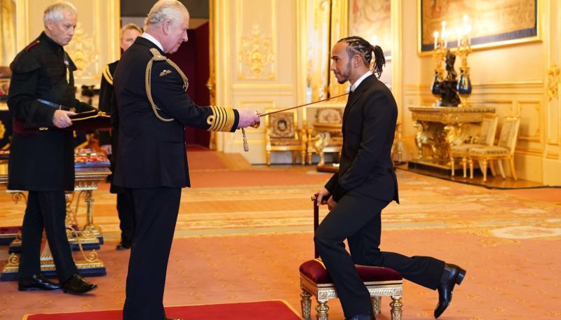 Lewis Hamilton receives his knighthood from Prince Charles