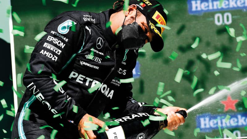 Lewis Hamilton sprays champagne on the podium after the 2021 Portuguese Grand Prix