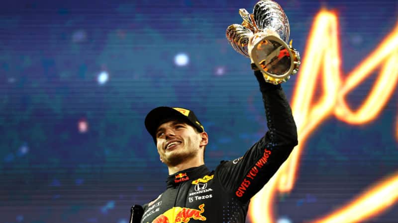 Max Verstappen lifts trophy after winnign Abu Dhabi GP and 2021 championship
