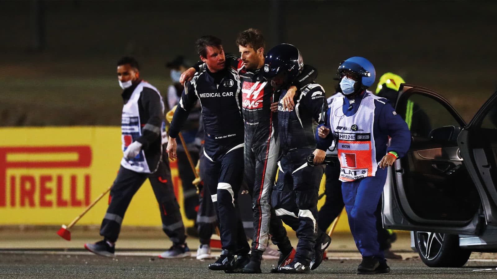 Romain Grosjean is helped away after 2020 Bahrain fireball crash