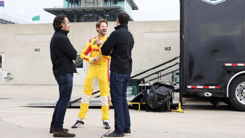 Romain Grosjean laughs with Jimmie Johnson and Dario Franchitti