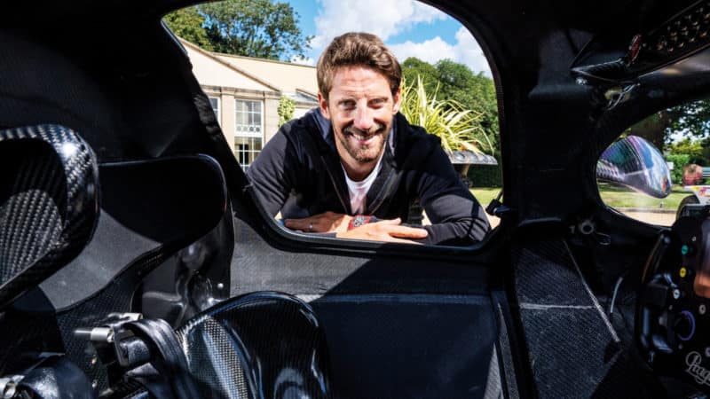 Romain Grosjean looks into Praga car cockpit