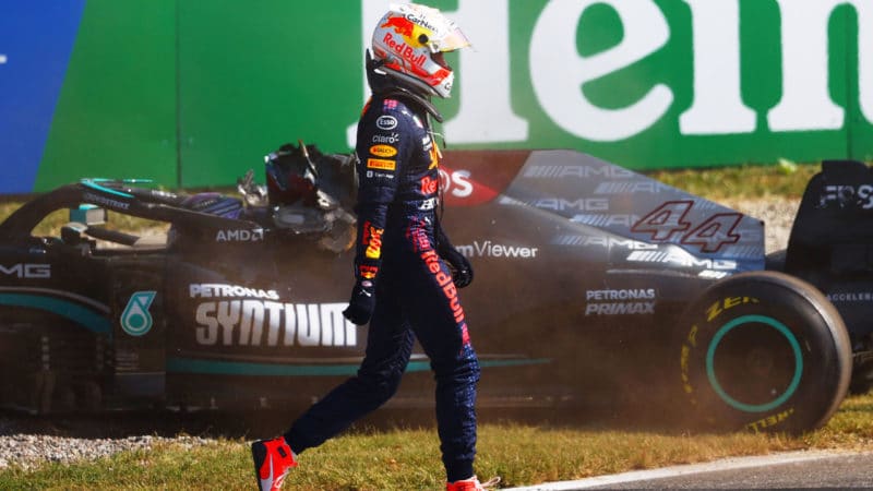 MONZA, ITALY - SEPTEMBER 12: Max Verstappen of the Netherlands and Red Bull Racing walks past the Lewis Hamilton of Great Britain and Mercedes AMG Petronas after they collided at the first chicane and crashed during the F1 Grand Prix of Italy at Autodromo di Monza on September 12, 2021 in Monza, Italy. (Photo by Dan Istitene - Formula 1/Formula 1 via Getty Images)