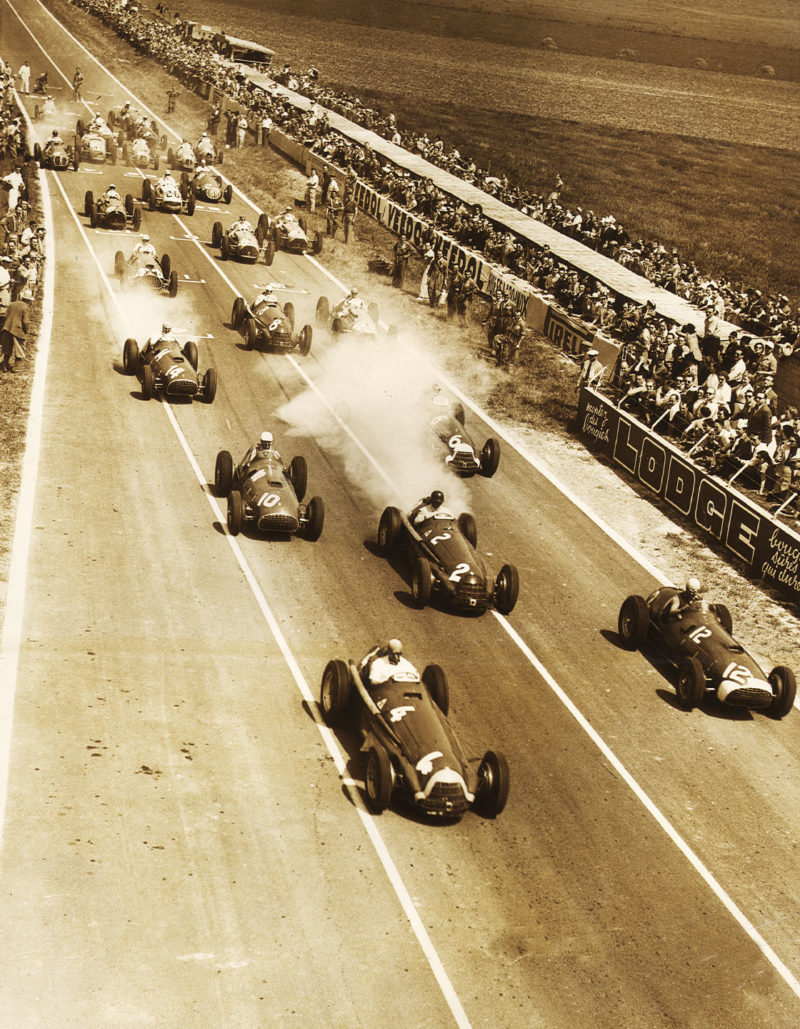 Juan Manuel Fangio of Argentina driving the #4 Alfa Romeo SpA Alfa Romeo 159A leads the field away from Alberto Ascari in the #12 Scuderia Ferrari Ferrari 375 at the start of the XXXVIII Grand Prix de l'ACF French Grand Prix on 1st July 1951 at the Reims-Gueux course in Reims, France. (Photo by Keystone/Getty Images)
