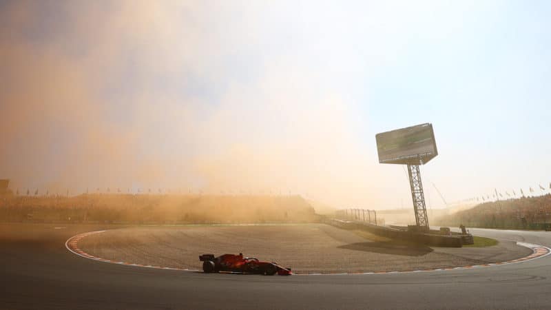 Charles Leclerc drives through orange smoke at Zandvoort
