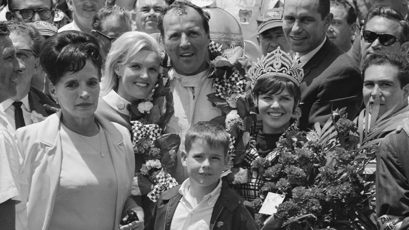 (Original Caption) This happy little group that is feeing mighty big has much to be happy about. A.J. Foyt just won the Indianapolis 500-mile race and he is sharing his victory with his wife (l), 500-mile Festival Queen Janice Louise Cruze, of Terre Haute, Indiana, and Allen Murphy, son of the winning car's sponsor. Foyt set a track record May 31 in winning the annual classic.
