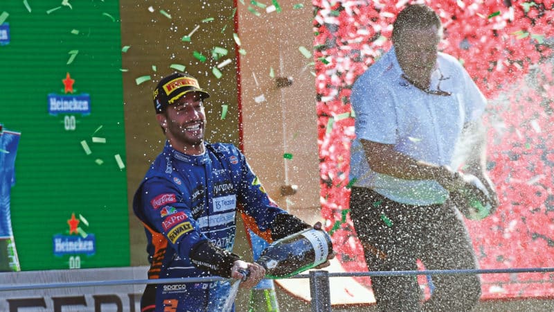 Daniel Ricciardo sprays champagne with Zak Brown after winning the 2021 Italian Grand Prix