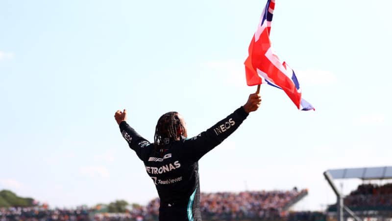 NORTHAMPTON, ENGLAND - JULY 18: Race winner Lewis Hamilton of Great Britain and Mercedes GP celebrates in parc ferme during the F1 Grand Prix of Great Britain at Silverstone on July 18, 2021 in Northampton, England. (Photo by Dan Istitene - Formula 1/Formula 1 via Getty Images)