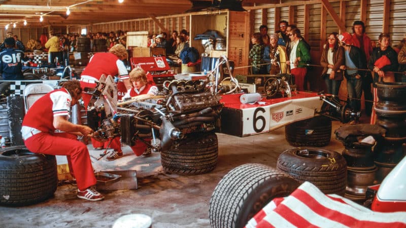 Mechanics work on the McLaren of Denny Hulme in 1974