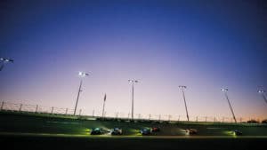 Cars on banking at dusk during 2022 Daytona 24