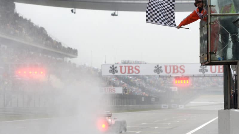 Chequered flag waves at the end of 2014 Chinese GP