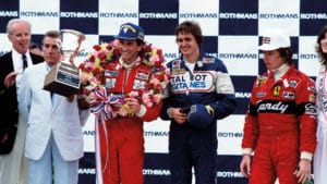 John-Watson-with-winning-tophy-from-US-GP