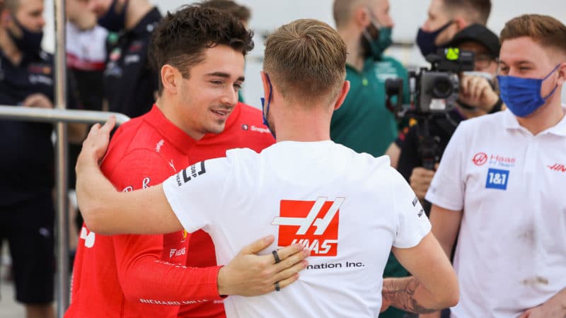Kevin Magnussen greets Charles Leclerc at 2022 Bahrain testing