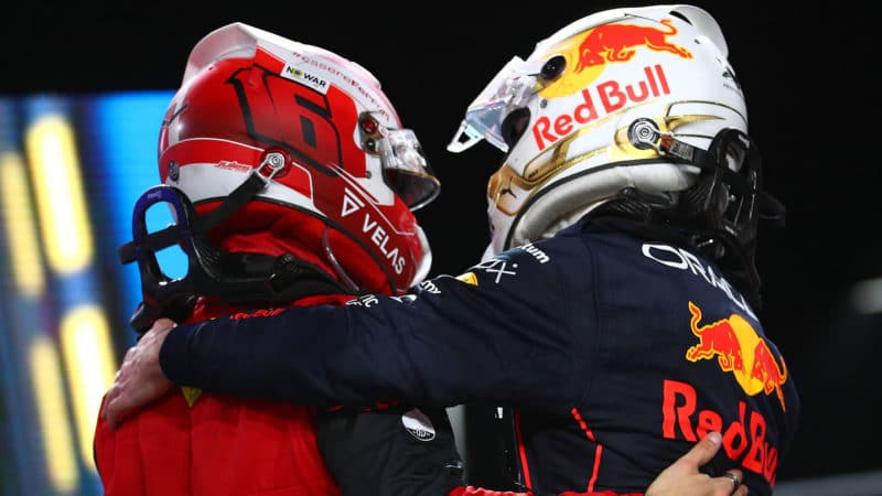 JEDDAH, SAUDI ARABIA - MARCH 27: Race winner Max Verstappen of the Netherlands and Oracle Red Bull Racing and Second placed Charles Leclerc of Monaco and Ferrari shake hands in parc ferme during the F1 Grand Prix of Saudi Arabia at the Jeddah Corniche Circuit on March 27, 2022 in Jeddah, Saudi Arabia. (Photo by Eric Alonso/Getty Images)