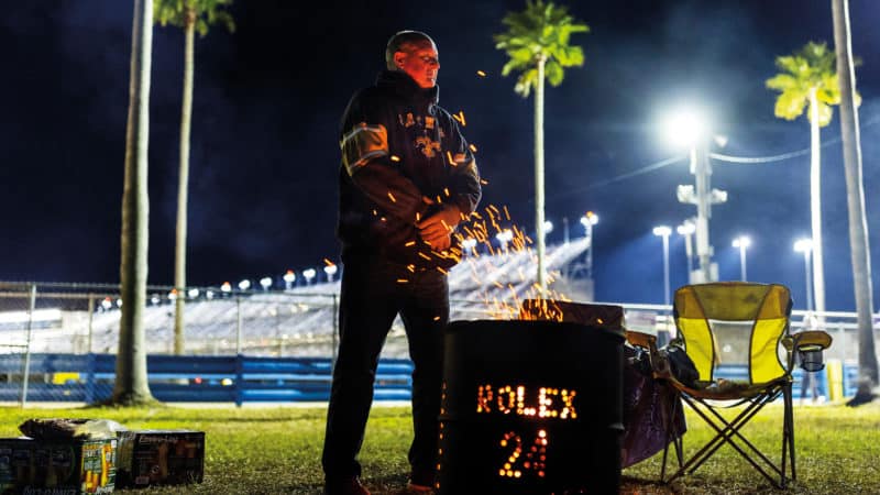 Man warms up by fire at 2022 Daytona 24