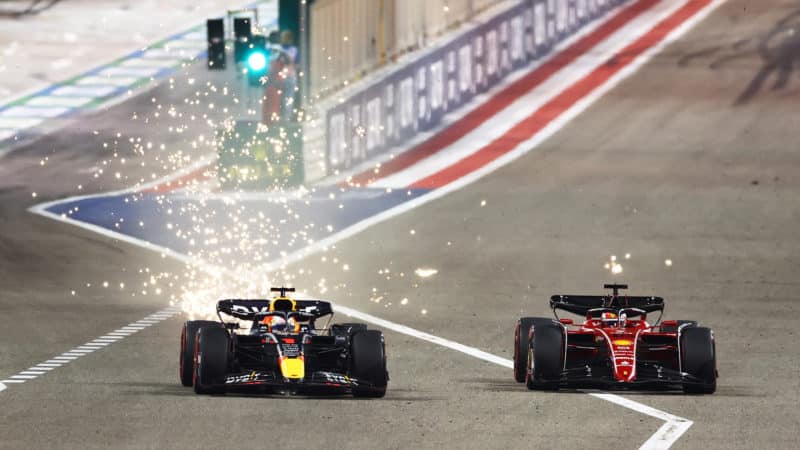 Max Verstappen passes Charles Leclerc in a shower of sparks at the 2022 F1 Bahrain Grand Prix