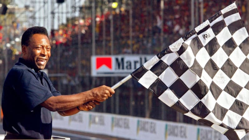 Pele waves chequered flag at the 2002 Brazilian GP