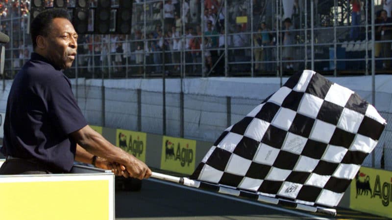 Pele waves chequered flag at the 2002 Brazilian Grand Prix
