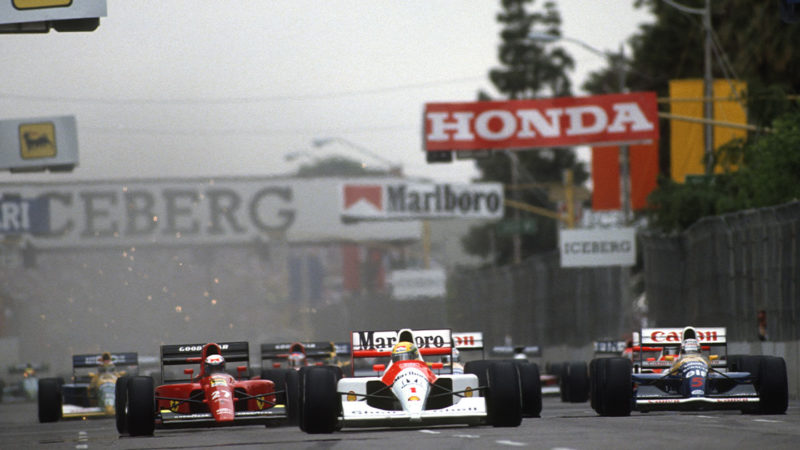 Ayrton Senna (McLaren-Honda), Nigel Mansell (Ferrari) and Alain Prost (Ferrari) lead the field at the start of the 1991 United States Grand Prix in Phoenix. Photo: Grand Prix Photo