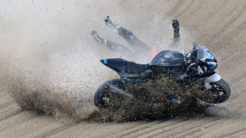 Scott Bacon crashes into the gravel at Paddock Hill Bend Brands Hatch