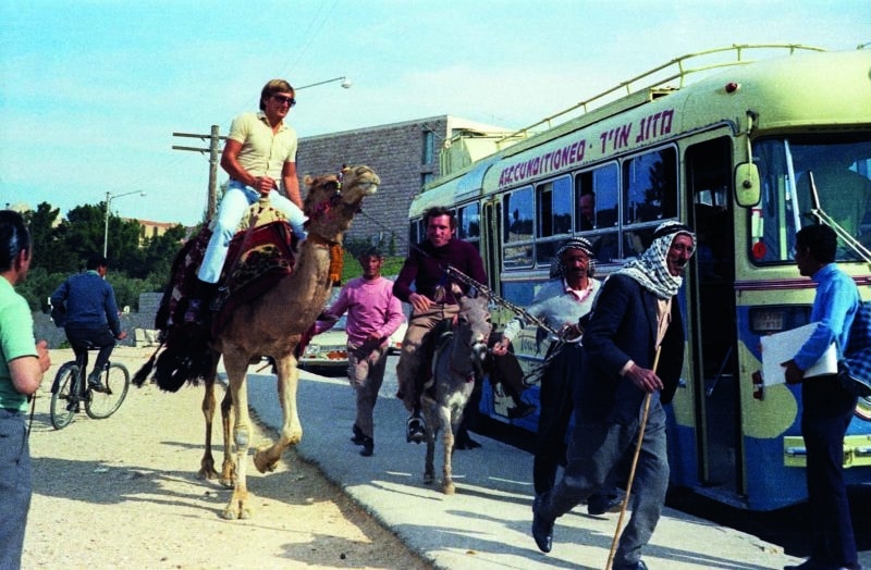 Derek Bell on a camel alongside Vittorio Brambilla on a donkey at the 1970 Israel Grand Prix