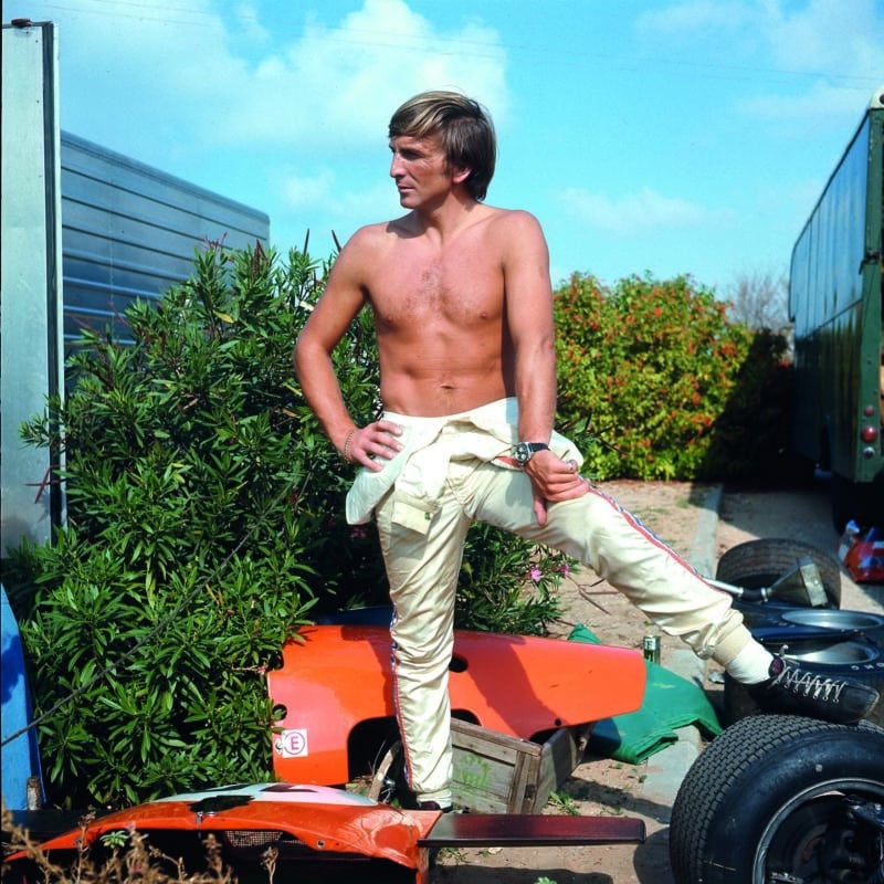 Derek Bell standing among car parts at the 1970 Israel Grand Prix