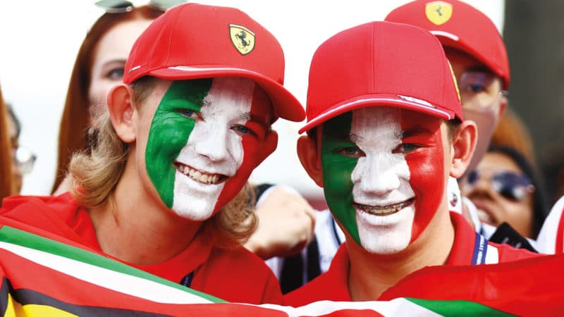 Ferrari fans with face painted the colours of the Italian flag
