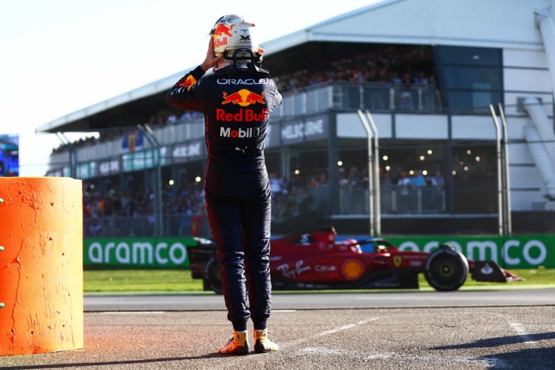 Max-Verstappen-watches-Charles-Leclerc-drive-past-after-retiring-from-the-2022-Australian-Grand-Prix