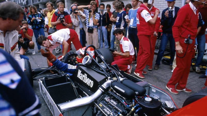 Niki Lauda in 1983 Mclaren with TAG Porsche engine exposed