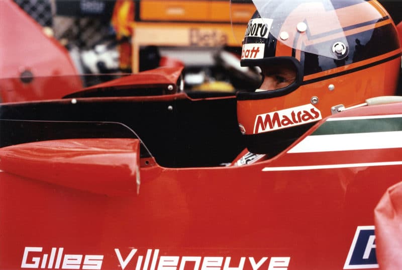 Side view of Gilles Villeneuve sitting in his Ferrari