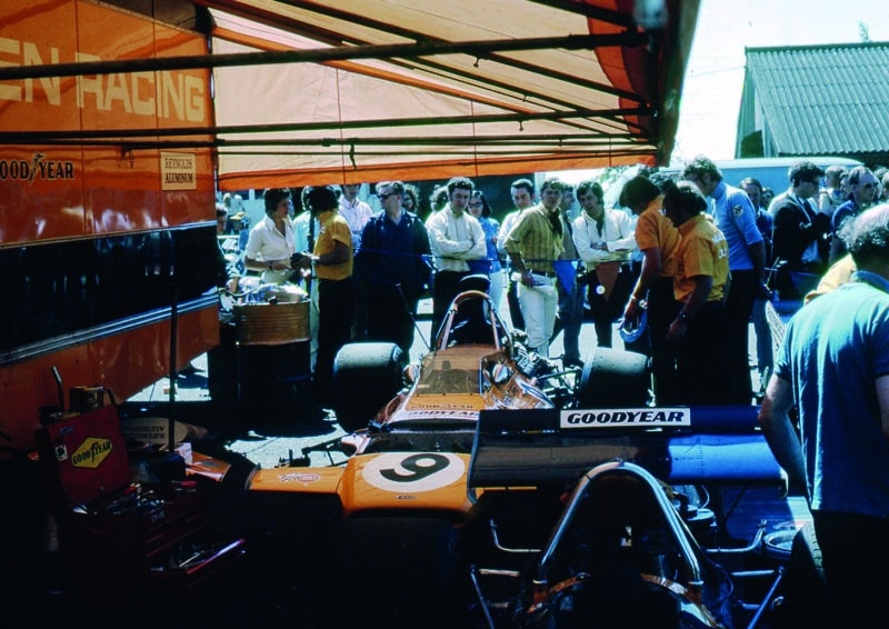 Spectators gather around McLaren M19 of Denny Hulme at Brands Hatch