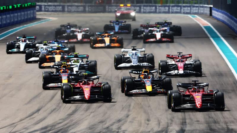 MIAMI, FLORIDA - MAY 08: Charles Leclerc of Monaco driving (16) the Ferrari F1-75 leads Max Verstappen of the Netherlands driving the (1) Oracle Red Bull Racing RB18, Carlos Sainz of Spain driving (55) the Ferrari F1-75 and the rest of the field into turn one at the start during the F1 Grand Prix of Miami at the Miami International Autodrome on May 08, 2022 in Miami, Florida. (Photo by Mark Thompson/Getty Images)