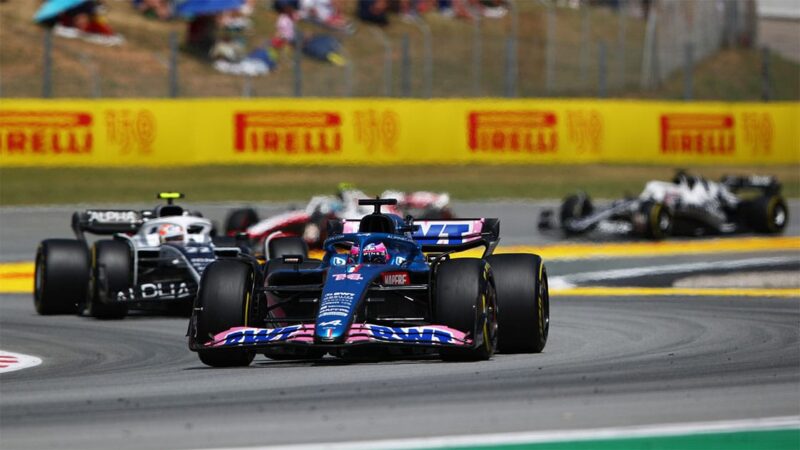 BARCELONA, SPAIN - MAY 22: Fernando Alonso of Spain driving the (14) Alpine F1 A522 Renault leads Yuki Tsunoda of Japan driving the (22) Scuderia AlphaTauri AT03 during the F1 Grand Prix of Spain at Circuit de Barcelona-Catalunya on May 22, 2022 in Barcelona, Spain. (Photo by Joe Portlock - Formula 1/Formula 1 via Getty Images)