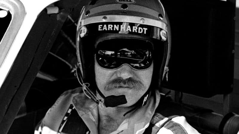 DAYTONA BEACH, FL - FEBRUARY 17, 1980: NASCAR driver Dale Earnhardt Sr. sits in his car at the Daytona International Speedway prior to the start of the 1980 Daytona 500 on February 17, 1980 in Daytona Beach, Florida. (Photo by Robert Alexander/Archive Photos/Getty Images)