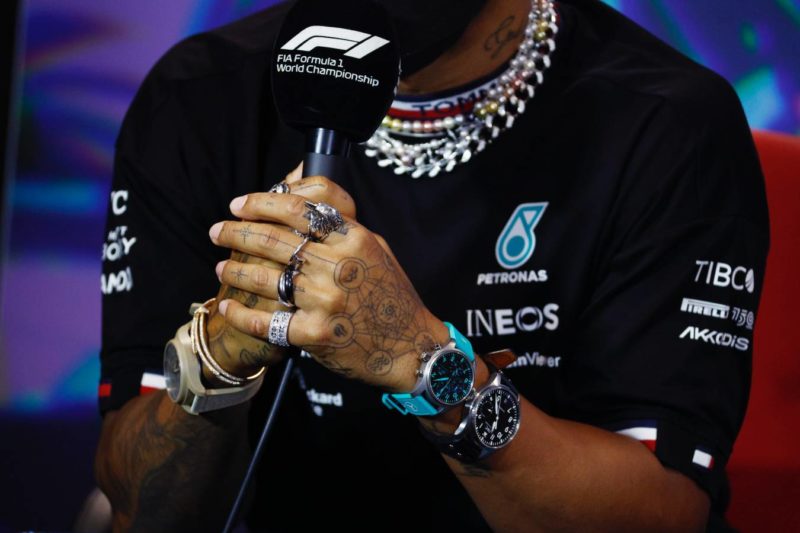 MIAMI, FLORIDA - MAY 06: A detail shot of the jewellery of Lewis Hamilton of Great Britain and Mercedes in the Drivers Press Conference prior to practice ahead of the F1 Grand Prix of Miami at the Miami International Autodrome on May 06, 2022 in Miami, Florida. (Photo by Jared C. Tilton/Getty Images)