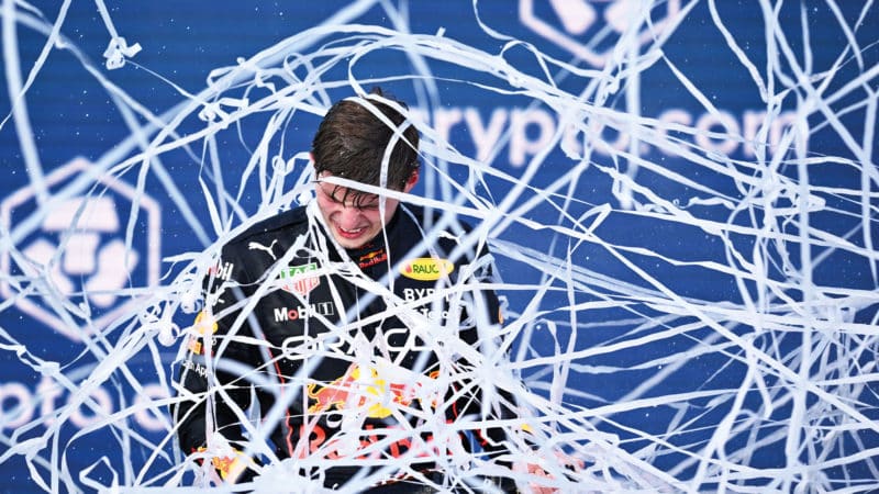 Max Verstappen caught up in streamers on the podium at the 2022 Miami Grand Prix