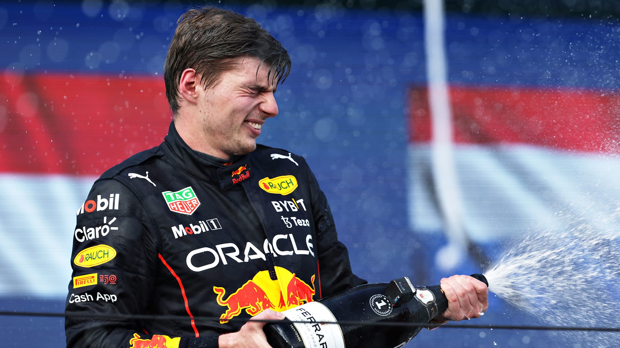 Max Verstappen sprays champagne on the poduum at the 2022 Miami Grand Prix