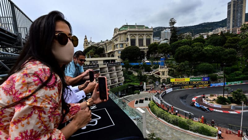Spectators watch from a rooftop as Alpine's Spanish driver Fernando Alonso drives during the third practice session at the Monaco street circuit in Monaco, on May 22, 2021, ahead of the Monaco Formula 1 Grand Prix. (Photo by ANDREJ ISAKOVIC / AFP) (Photo by ANDREJ ISAKOVIC/AFP via Getty Images)